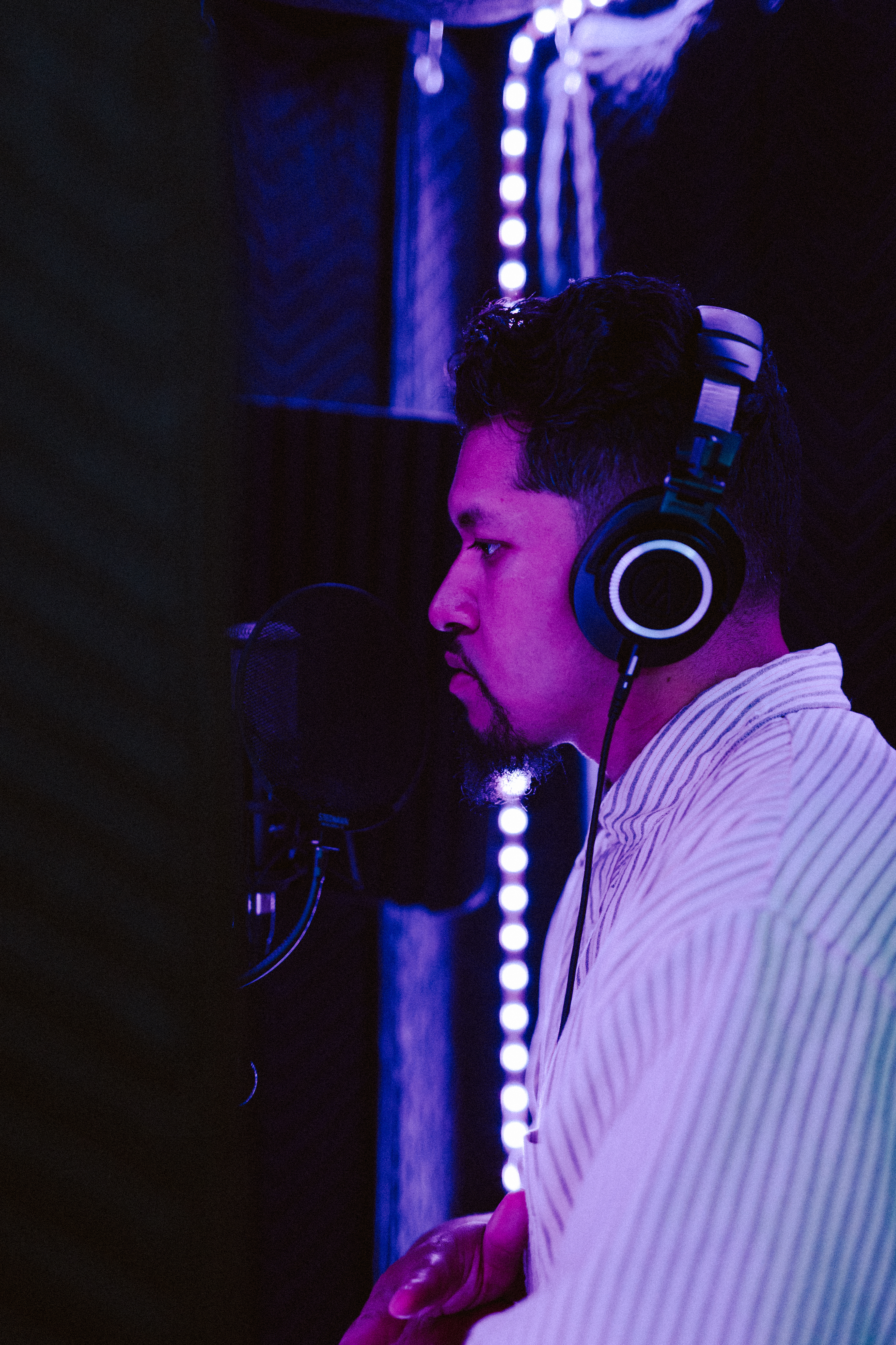 Artist performing into a studio microphone